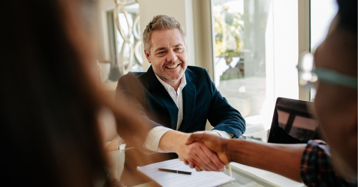 An agent and client shaking hands
