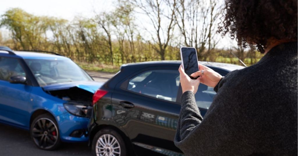 Woman taking a photo of a fender bender