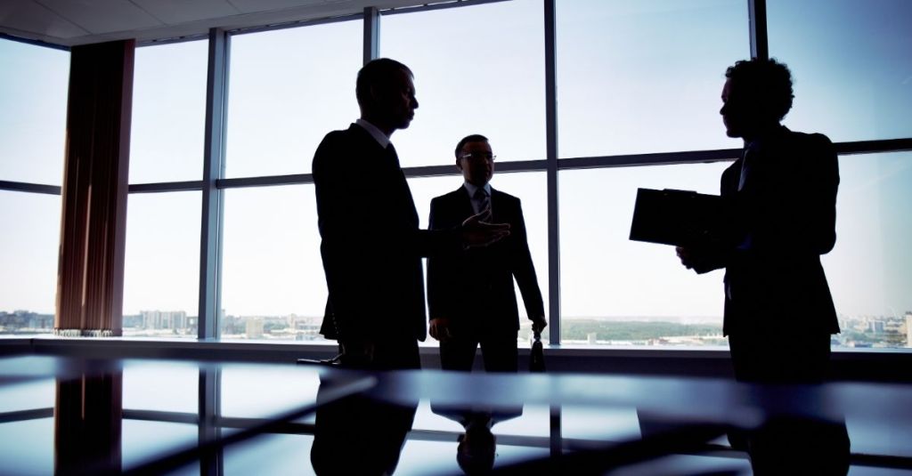 Three men talking in an office