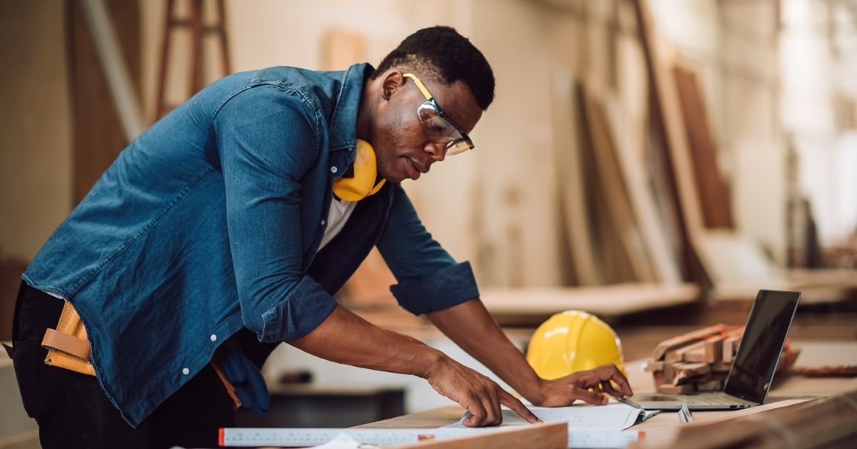 Contractor looking at floor plan