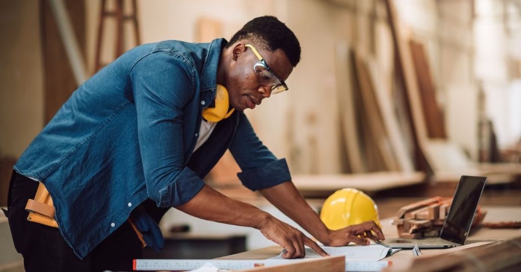 Contractor looking at floor plan