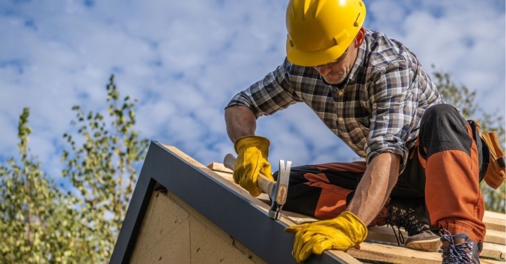 Contractor using a hammer on a roof