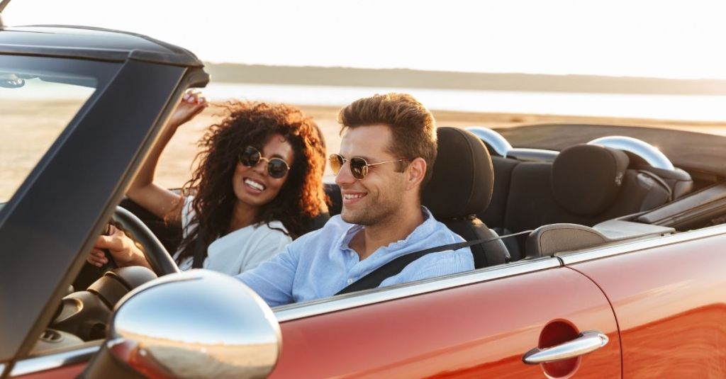 Couple riding together in a convertible