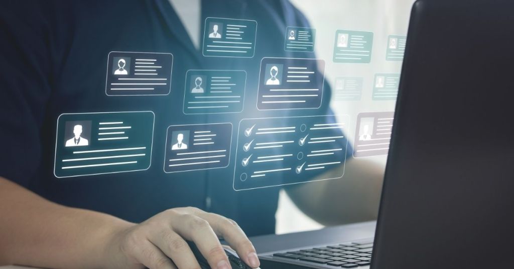 Man on computer with face icons hovering over screen