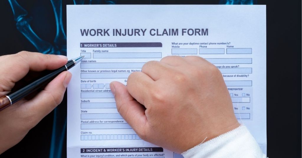 Person filling out a work injury claim form