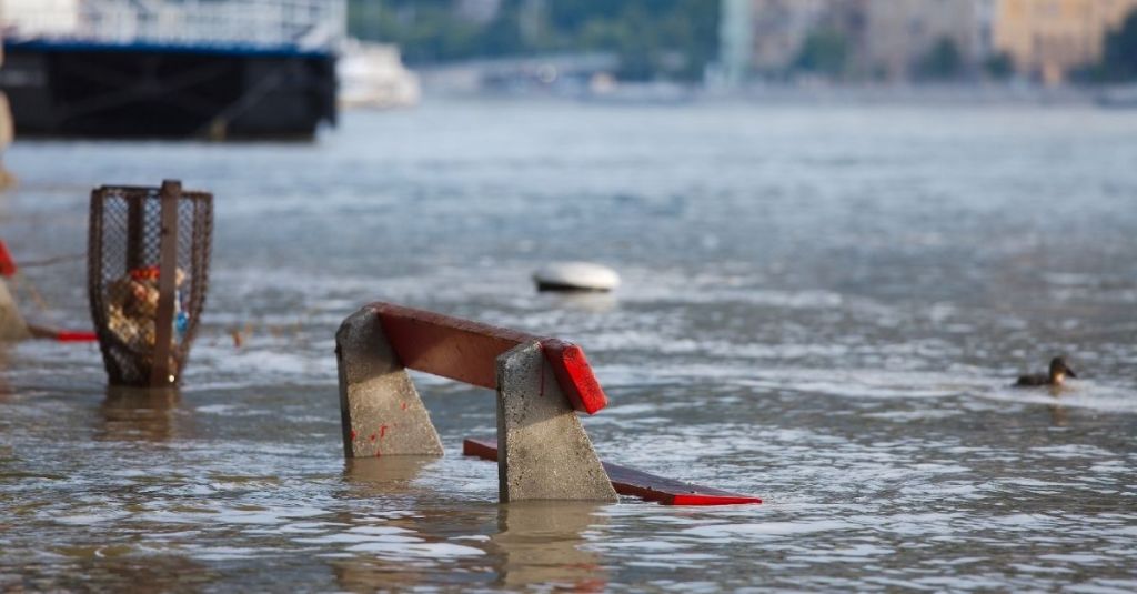 Street bench in a flooded road