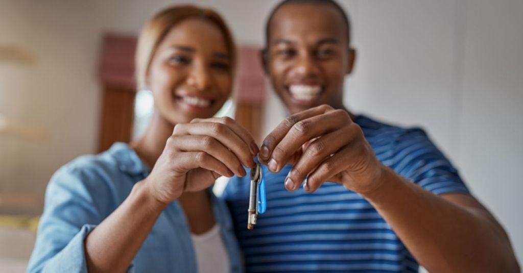 A couple holding a pair of keys