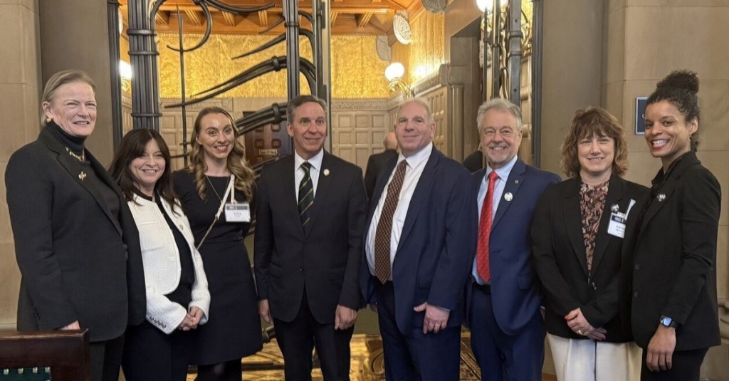 Members with a congressman at the G100 Day on the Hill 2025