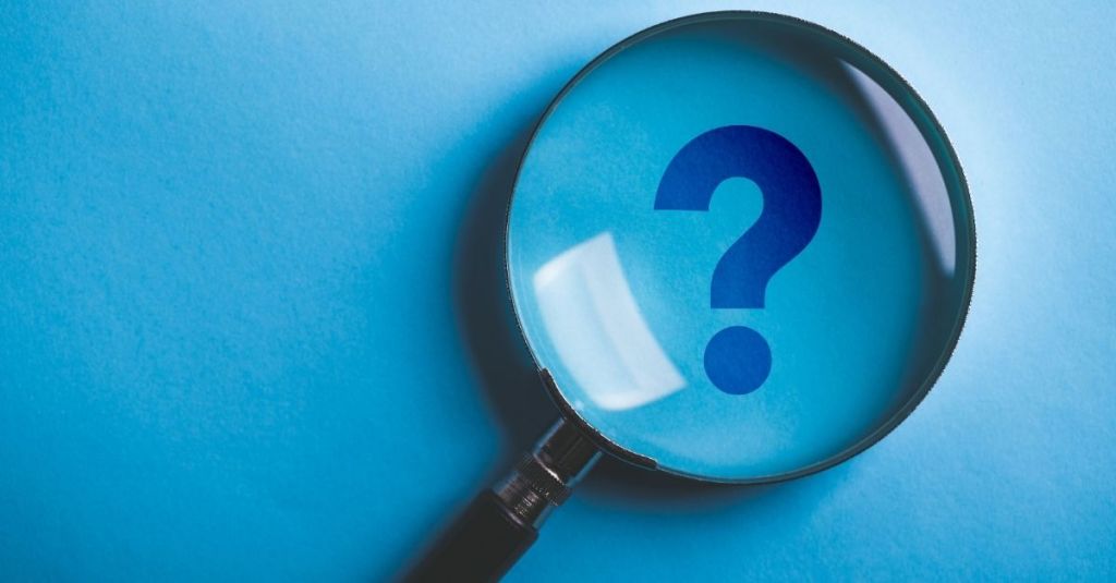 Magnifying glass above a question mark