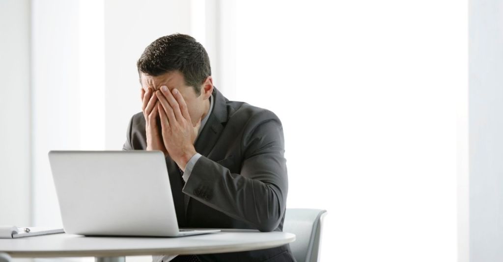 Man in distress with his face in his hands