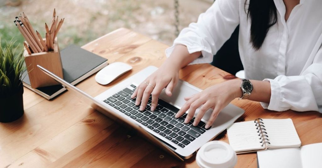Woman typing on a laptop
