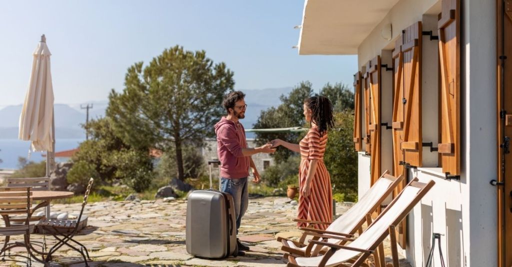 Property owner handing off keys to the guest who's renting the house