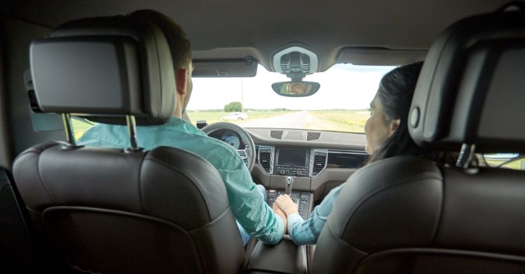 Couple in a car sitting in the front seats