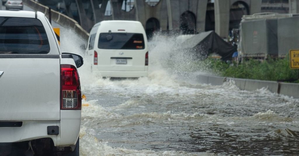 Cars driving through a flooded road