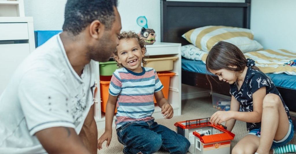 Foster children playing with their foster parent