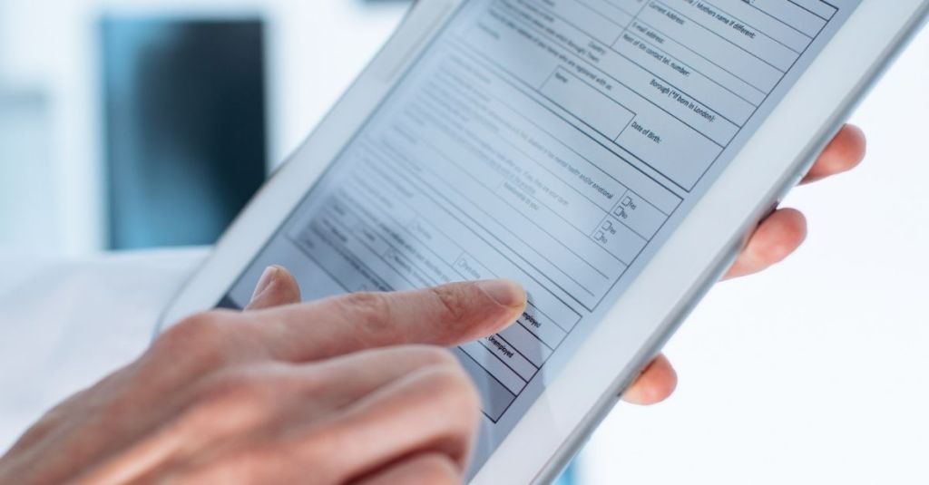 Person pointing with finger on a tablet