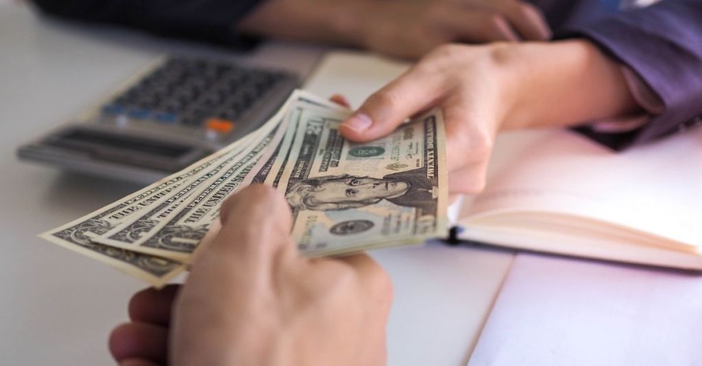 Person giving another person money