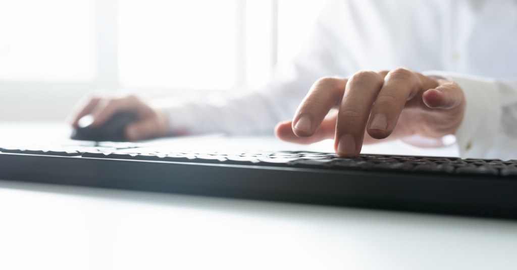 A person typing on a keyboard