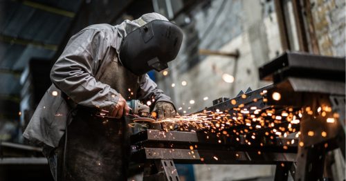 Industrial worker welding steel
