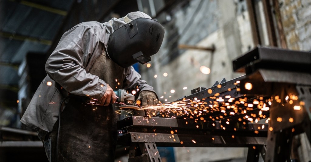 Industrial worker welding steel