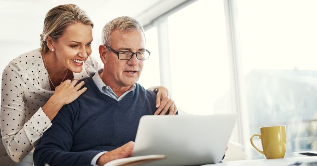 Retired couple looking at laptop screen
