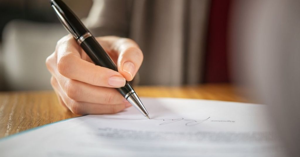 Woman signing document