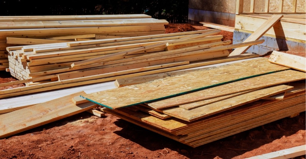 A construction site with stacked lumber building materials