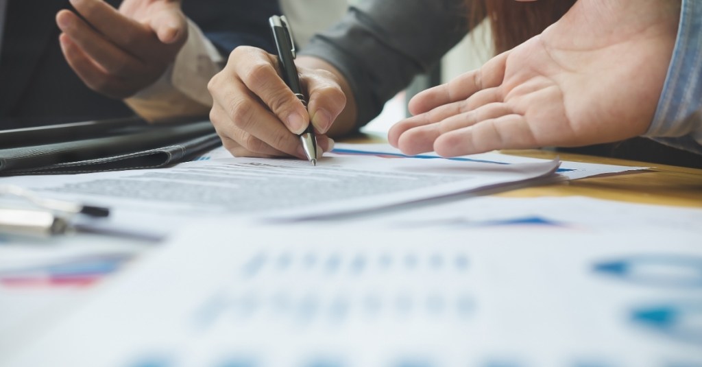 Low view of a person writing on a piece of paper