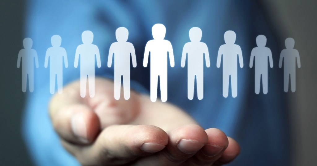 A person holding a graphic of a row of people