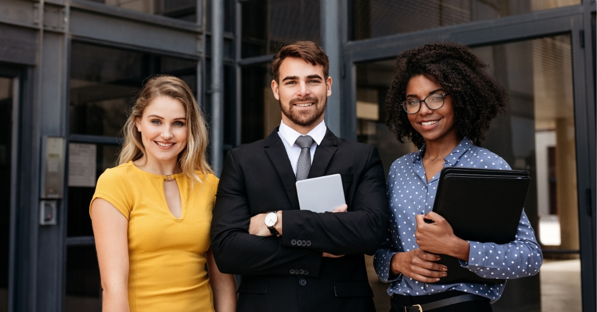 A group of young business professionals standing together side by side