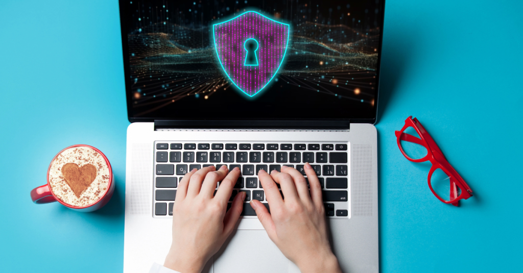 Hands typing on a laptop with code and a lock on the screen